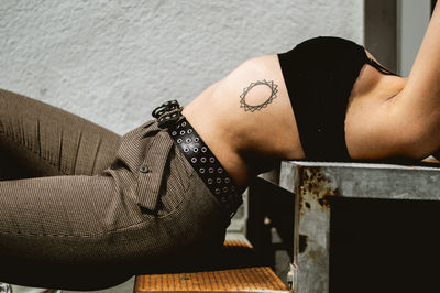 Midsection of woman lying on floor