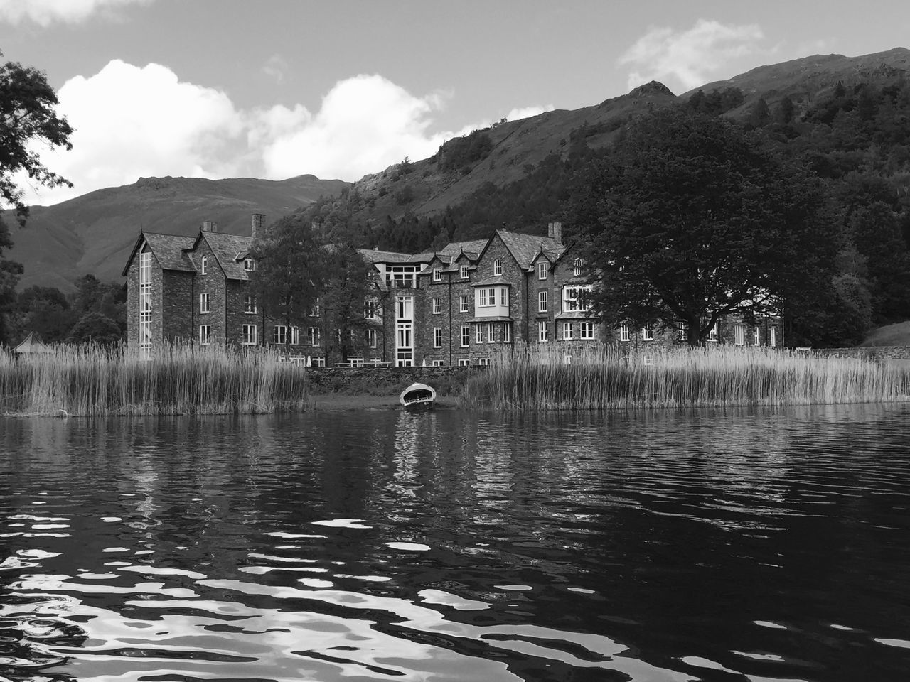 building exterior, architecture, water, built structure, mountain, waterfront, sky, house, tree, river, lake, reflection, rippled, residential structure, residential building, nature, day, cloud, outdoors, cloud - sky