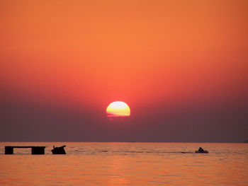 Scenic view of sea against orange sky