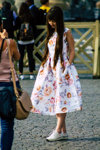 Women walking on sidewalk in city