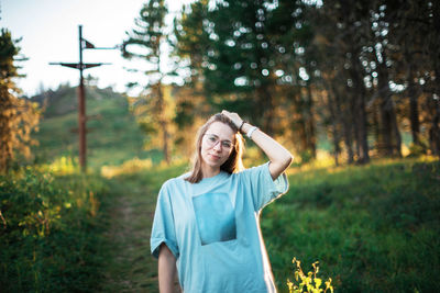 Portrait of smiling young woman in forest