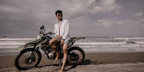 Man riding bicycle on beach