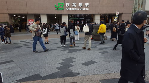 People walking on footpath in city