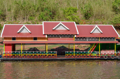 House by river against building