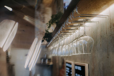 Close-up of wineglasses hanging in bar