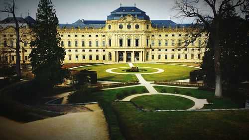 View of fountain in front of palace