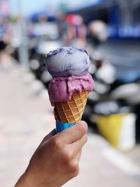 Cropped hand holding ice cream cone