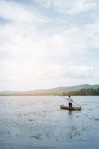 Man on boat against sky