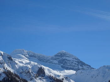 Scenic view of snowcapped mountains against clear blue sky