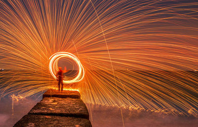Low angle view of firework display in tunnel