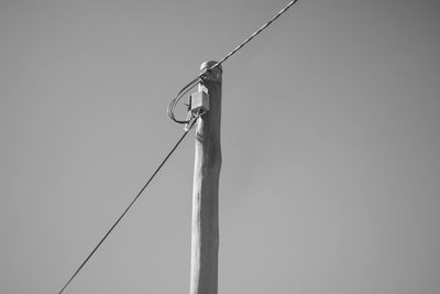 Low angle view of power line against clear sky