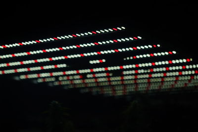 Low angle view of illuminated lights at night