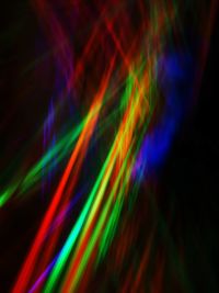 Close-up of colorful light trails against black background