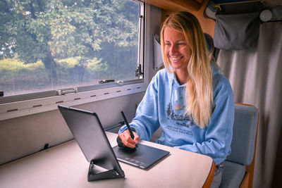 Portrait of young woman using laptop