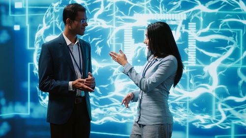 Side view of business people standing against wall