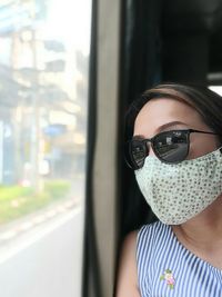 Young woman wearing sunglasses and mask