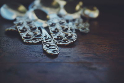 Close-up of silver spoons on wooden table