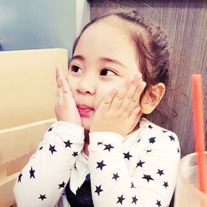 Close-up portrait of happy girl at home