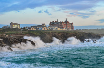 Scenic view of sea against buildings in city