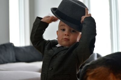 Portrait of cute baby boy wearing hat while standing at home