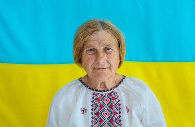 Portrait of senior woman in front of ukrainian flag