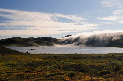 Scenic view of sea and mountains against sky