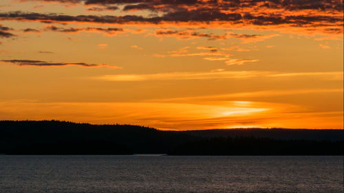 Scenic view of sea against romantic sky at sunset