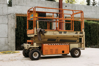 Scissor lift platform on a construction site. building concreate house with mobile transportation