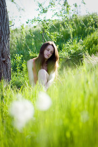 Portrait of young woman on field