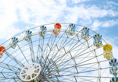 Low angle view of ferris wheel against sky