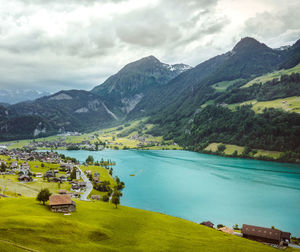 Scenic view of lake and mountains against sky