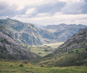 Scenic view of mountains against cloudy sky