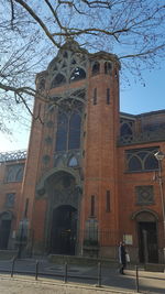 Low angle view of cross against building