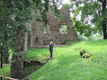 Rear view of man walking by plants