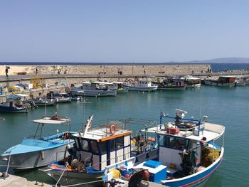 High angle view of boats moored in sea against clear sky