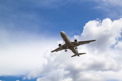 Low angle view of airplane flying in sky