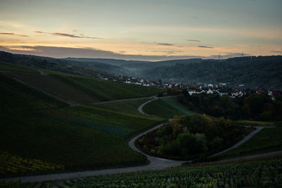 Scenic view of agricultural field against sky during sunset