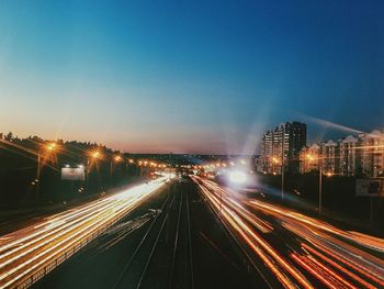 High angle view of light trails on highway at night