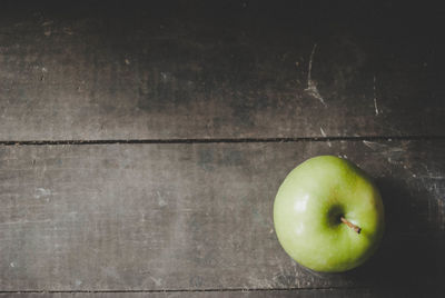 Directly above shot of apple on table against wall