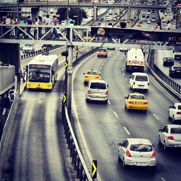 transportation, car, land vehicle, mode of transport, architecture, built structure, street, city, road, high angle view, traffic, building exterior, travel, city life, incidental people, in a row, on the move, outdoors, bus, city street