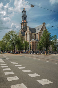 View of city street and buildings against sky