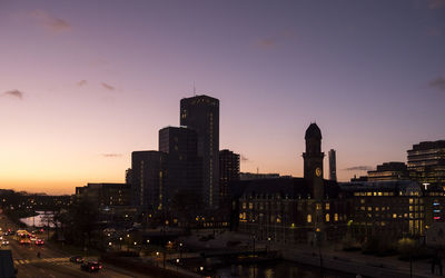 View of city lit up at sunset