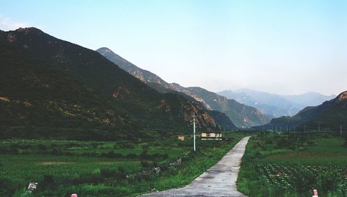 Country road leading towards mountains