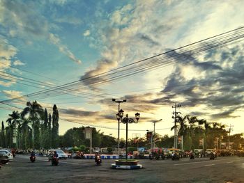 Cars on street against sky