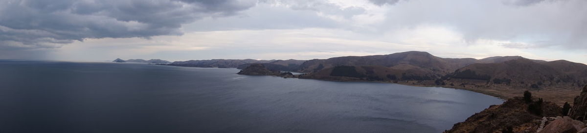 Panoramic view of sea and mountains against sky