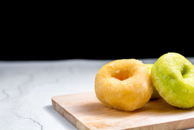 Close-up of apple on table against black background