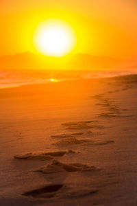 Scenic view of beach against sky during sunset