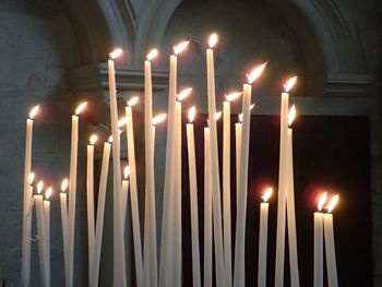 Close-up of illuminated candles in temple