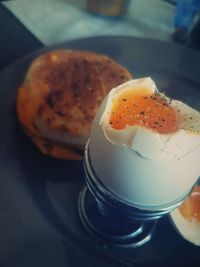 Close-up of boiled egg on eggcup in plate