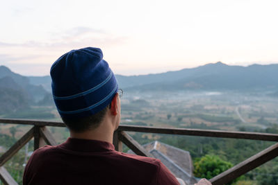 Rear view of man looking at mountains